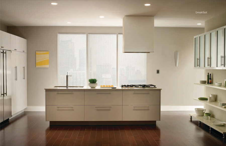 A modern kitchen in a Manhattan apartment featuring Lutron motorized shades on the windows.