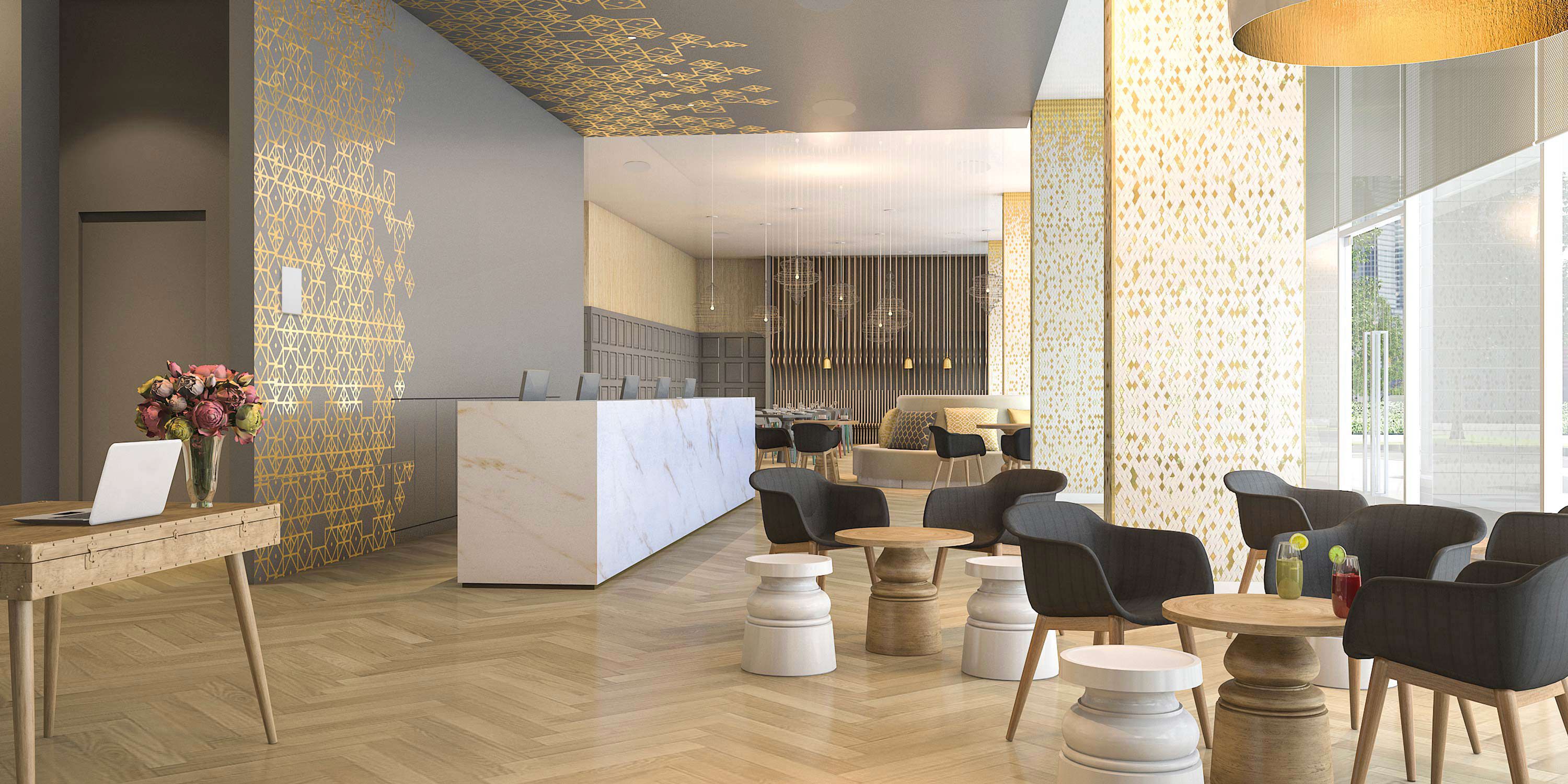 hotel lobby with gold accents and wood herringbone floors